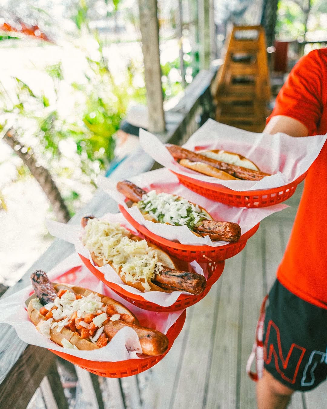 A lineup of Dune Dog signature hot dogs in baskets